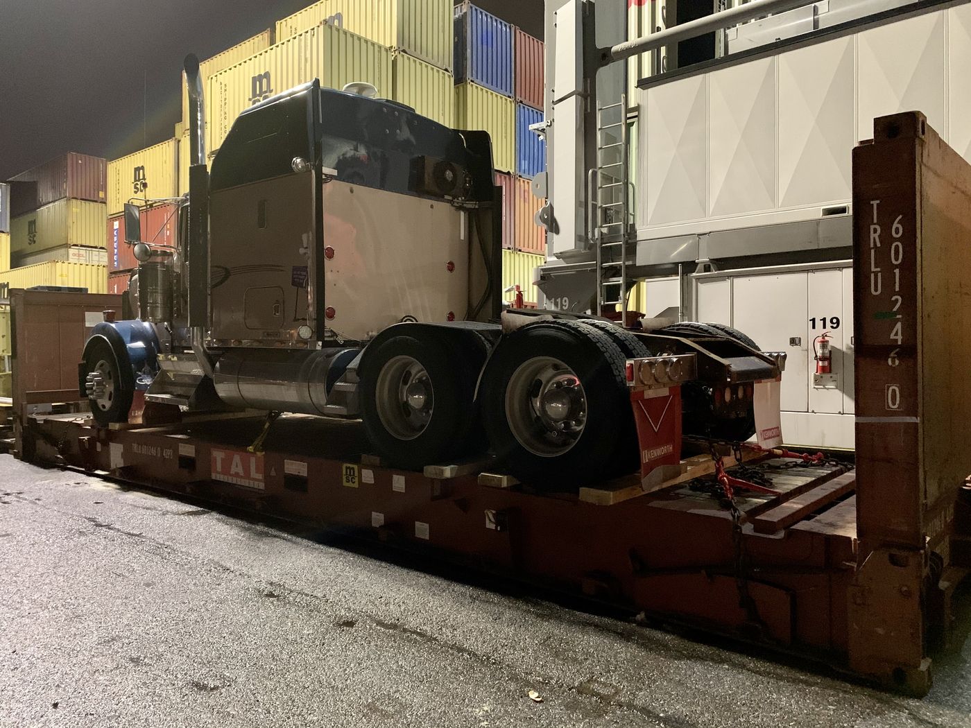 Truck secured on a flat rack container at the terminal